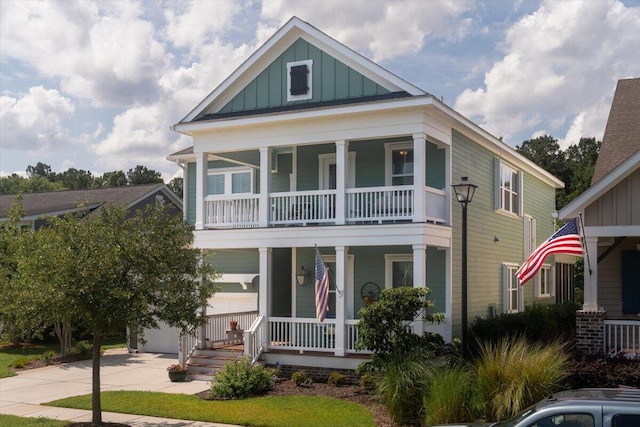 view of front facade with a porch, a garage, board and batten siding, and concrete driveway