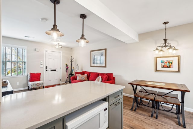 kitchen with decorative light fixtures and light wood-type flooring