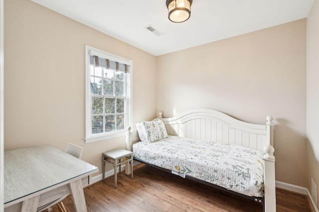 bedroom with hardwood / wood-style flooring