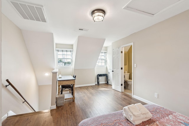 bedroom featuring ensuite bath and hardwood / wood-style flooring