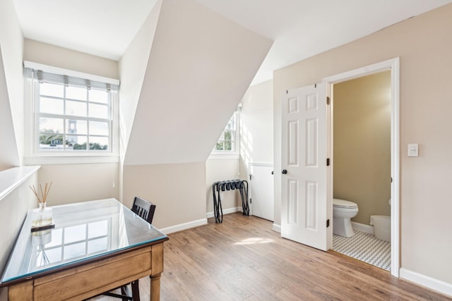 office area featuring light hardwood / wood-style floors and vaulted ceiling