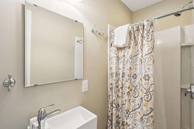 bathroom with sink and walk in shower