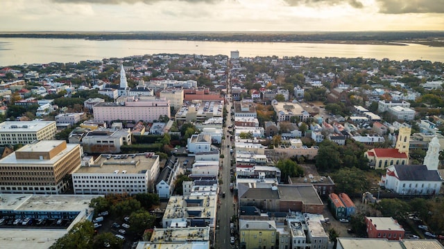 aerial view at dusk featuring a water view