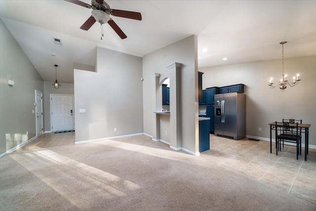 living room featuring ceiling fan with notable chandelier, lofted ceiling, and light carpet