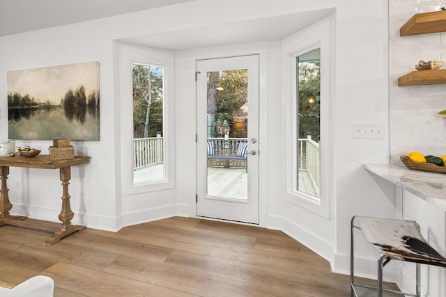 doorway with light wood-type flooring