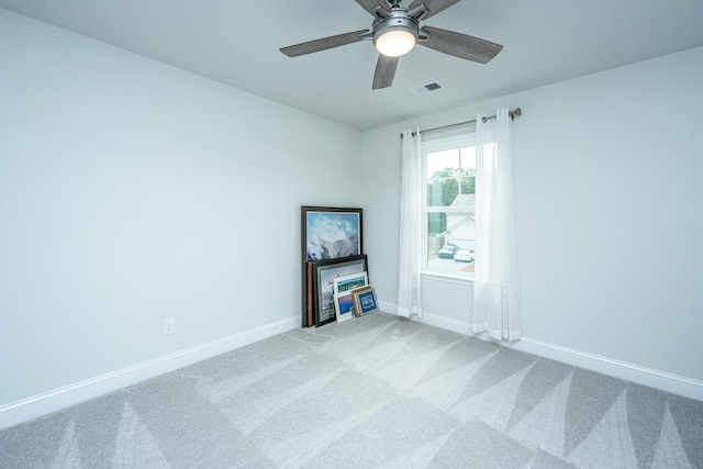 carpeted empty room featuring ceiling fan