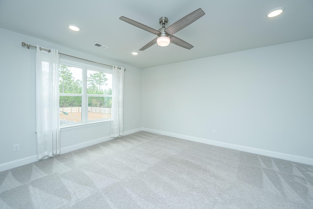 spare room with light carpet and ceiling fan