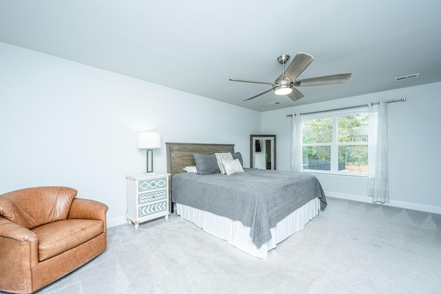 bedroom with ceiling fan and light carpet