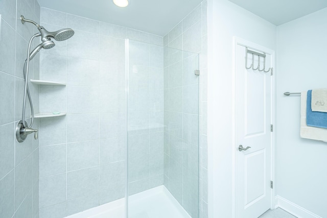 bathroom with a tile shower