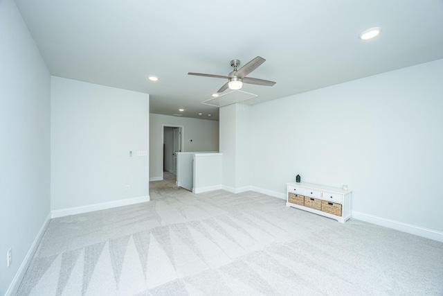 spare room featuring ceiling fan and light colored carpet