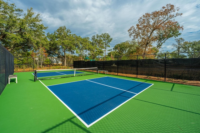 view of tennis court featuring basketball court