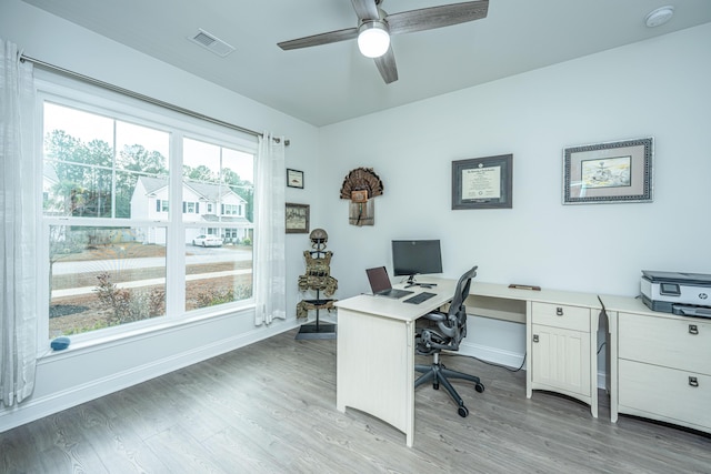 home office featuring light wood-type flooring and ceiling fan