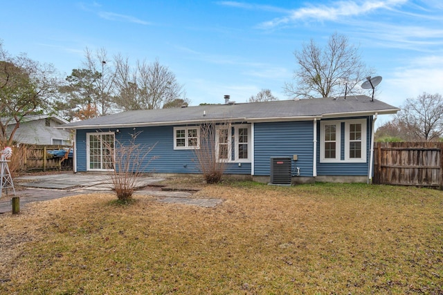 back of property featuring a lawn, central AC unit, and a patio