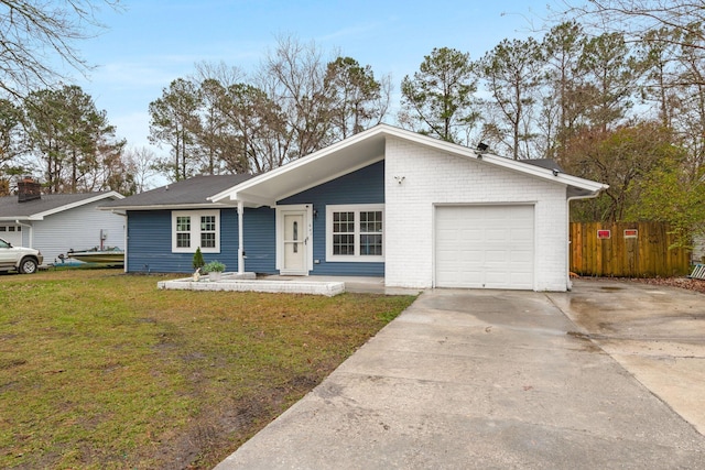 ranch-style home with a garage and a front lawn