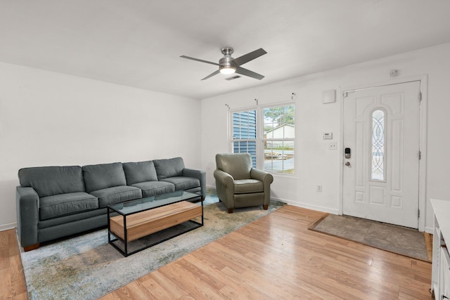 living room featuring ceiling fan and light hardwood / wood-style flooring