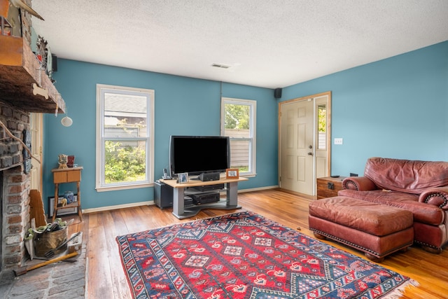 1485 Kinloch Ln, Mount Pleasant, SC 29464 - living area featuring a fireplace, wood-type flooring, a textured ceiling, and baseboards