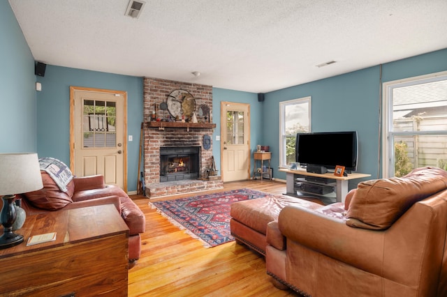 1485 Kinloch Ln, Mount Pleasant, SC 29464 - living area featuring a textured ceiling, light wood-style flooring, and a fireplace