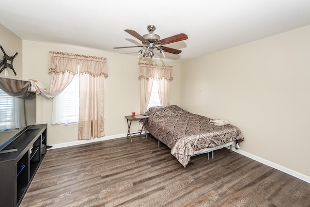 bedroom featuring multiple windows, ceiling fan, and dark hardwood / wood-style floors