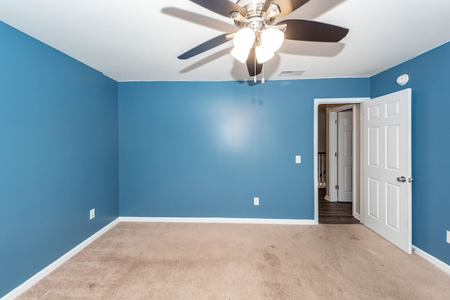 carpeted empty room with ceiling fan