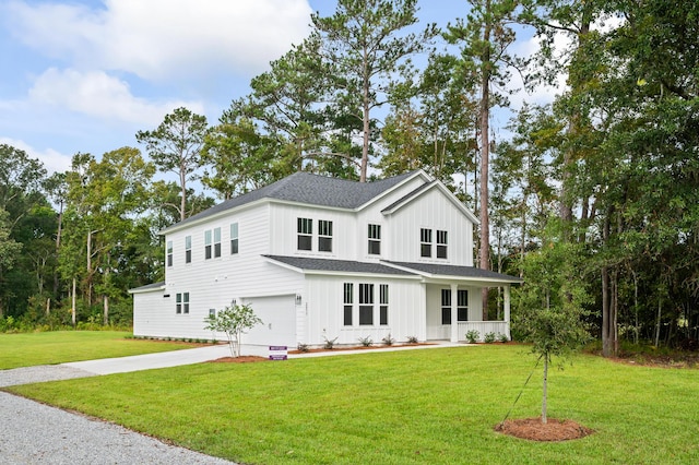 modern inspired farmhouse featuring a porch, a front yard, and a garage