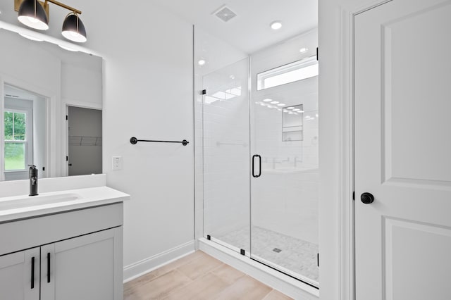 bathroom featuring vanity and an enclosed shower