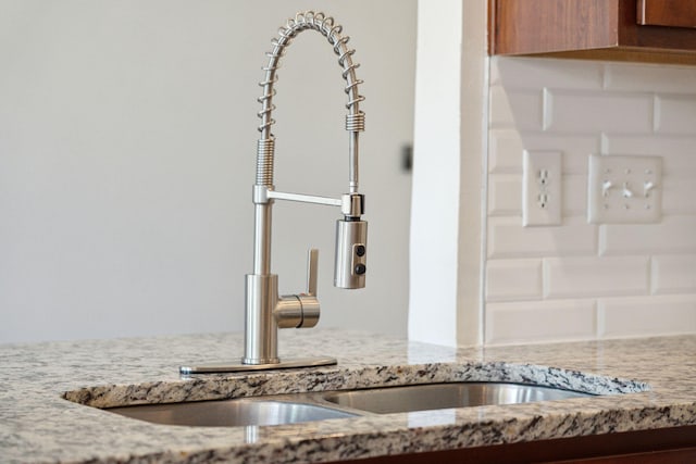 room details with light stone counters and sink