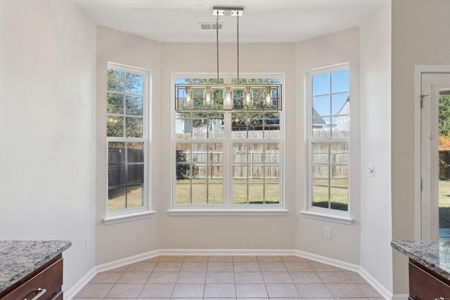 unfurnished dining area featuring light tile patterned flooring and a healthy amount of sunlight