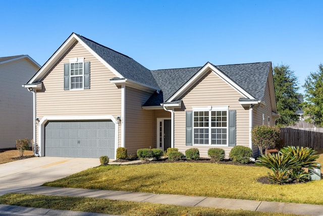 view of property featuring a front lawn and a garage