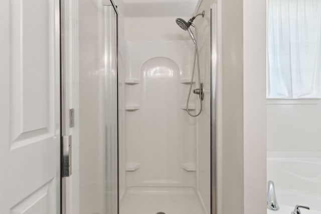 bathroom with a shower with shower door