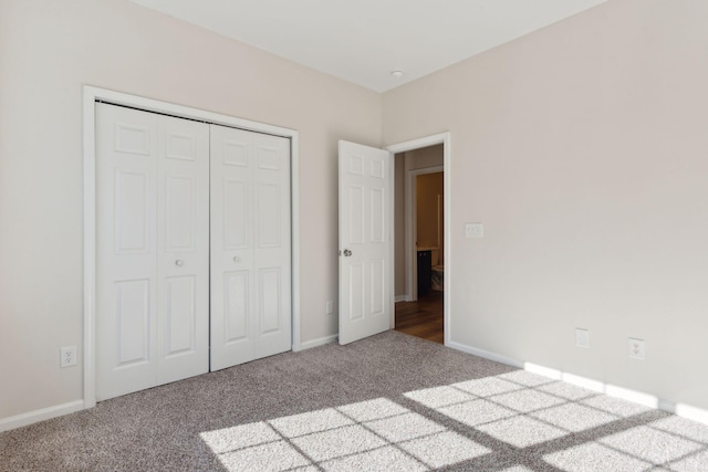 unfurnished bedroom featuring carpet and a closet