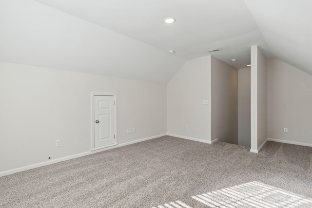 bonus room featuring light colored carpet and vaulted ceiling