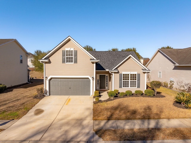 view of property featuring a front yard and a garage