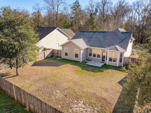 rear view of property featuring a yard and a patio