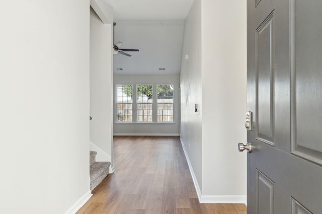 corridor with light hardwood / wood-style flooring