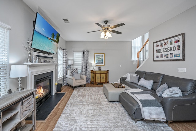 9636 Pebble Creek Blvd, Summerville, SC 29485 - living area with wood finished floors, a ceiling fan, a fireplace with flush hearth, and plenty of natural light