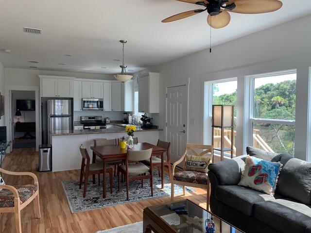 dining area featuring light wood-style floors and ceiling fan