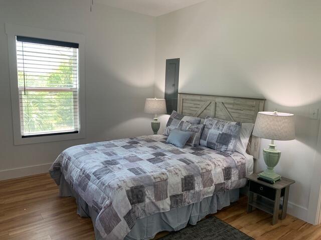 bedroom featuring wood finished floors and baseboards