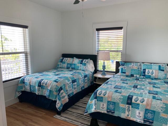 bedroom with ceiling fan and wood finished floors