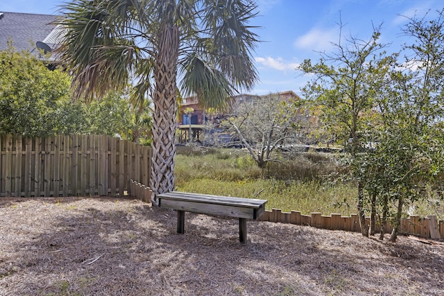 view of home's community featuring fence