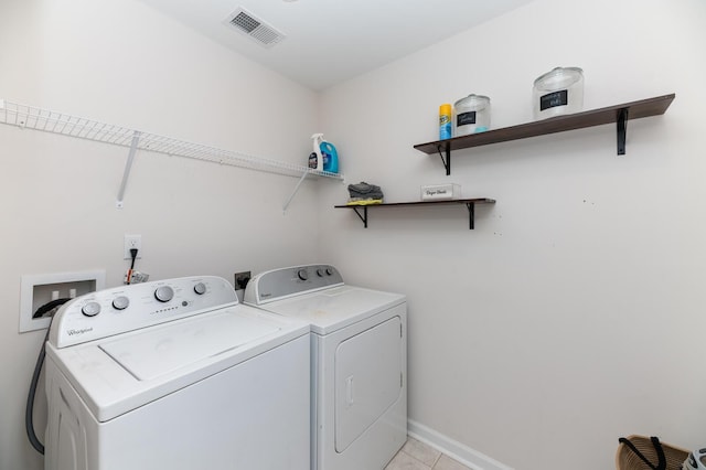 washroom featuring washer and dryer and light tile patterned floors