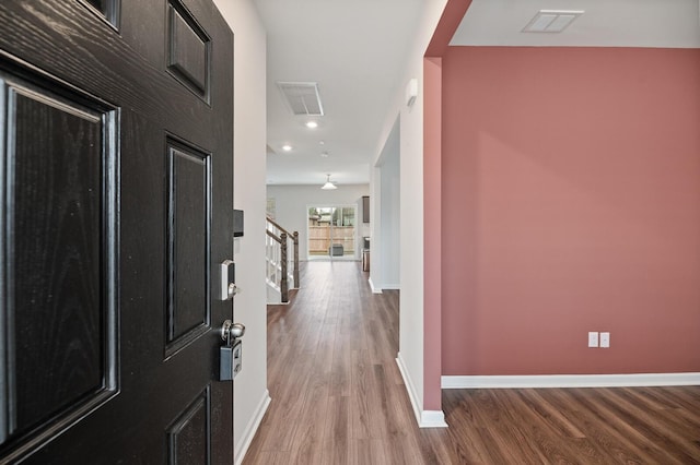 entryway with hardwood / wood-style floors