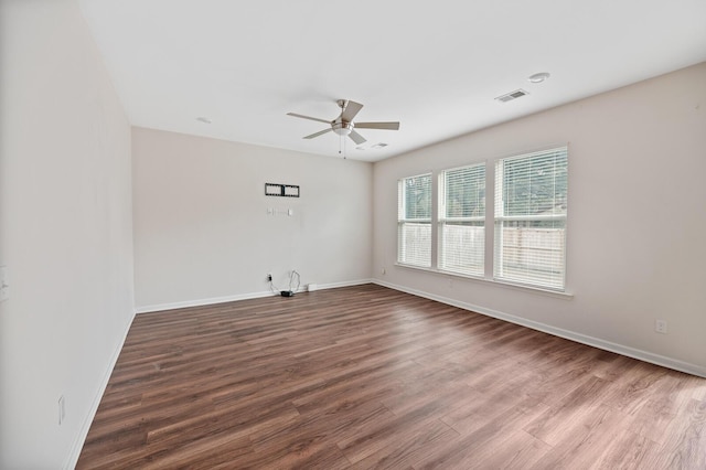 spare room featuring wood-type flooring and ceiling fan