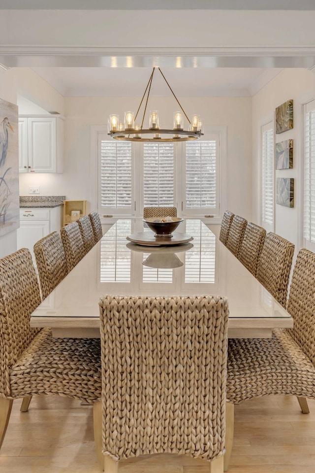 dining area with breakfast area, light hardwood / wood-style floors, and a chandelier