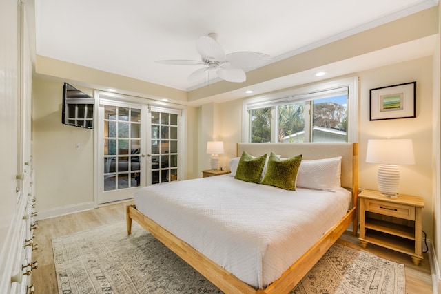 bedroom with ceiling fan, wood-type flooring, ornamental molding, and french doors