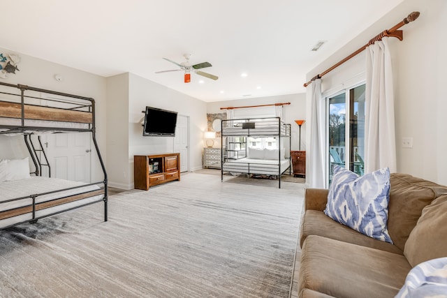 living room featuring light carpet and ceiling fan