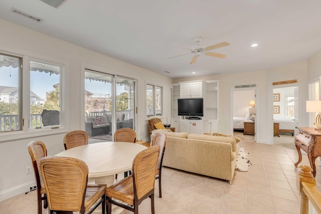 living room featuring light tile patterned floors and ceiling fan