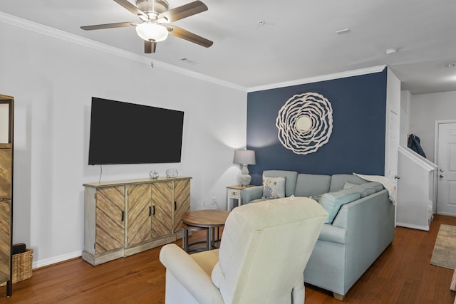 living area with a ceiling fan, wood finished floors, visible vents, and crown molding