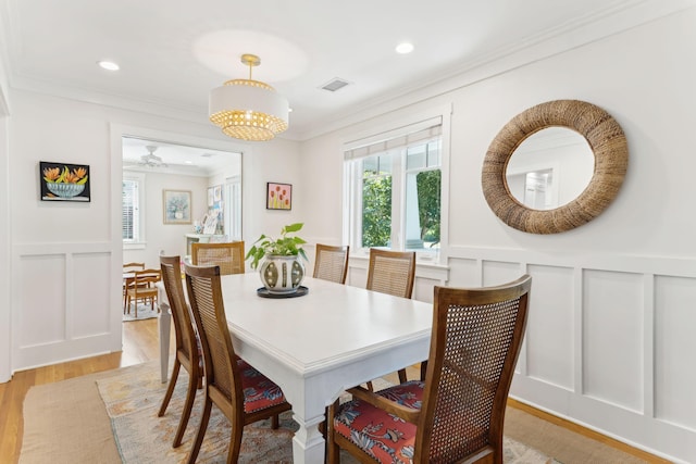 dining room featuring crown molding and light wood-type flooring