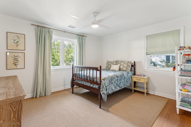 bedroom with crown molding, ceiling fan, and wood-type flooring