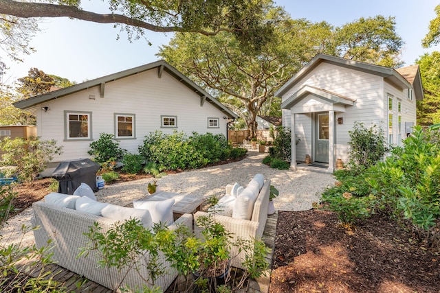 back of property featuring a patio area and outdoor lounge area